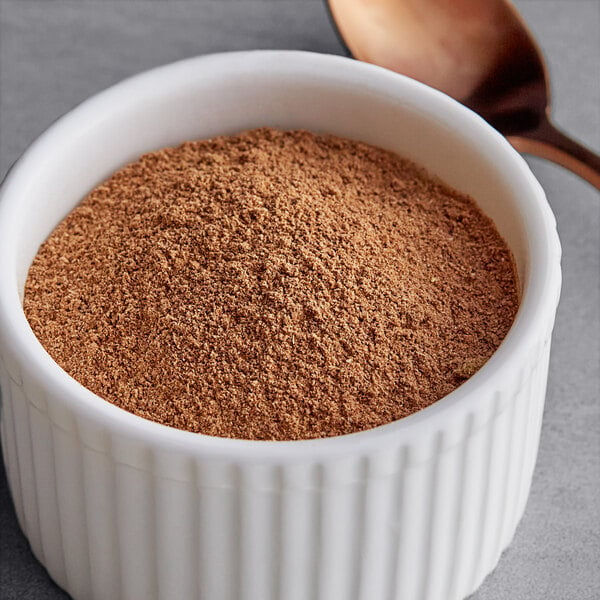 A bowl of brown Regal Warm Chai seasoning with a spoon.