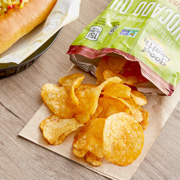 A bag of Good Health Avocado Oil Barbecue Kettle Chips next to a hot dog.
