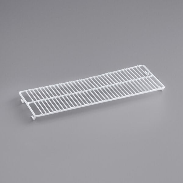 A white coated wire shelf for a lower Avantco countertop display freezer.