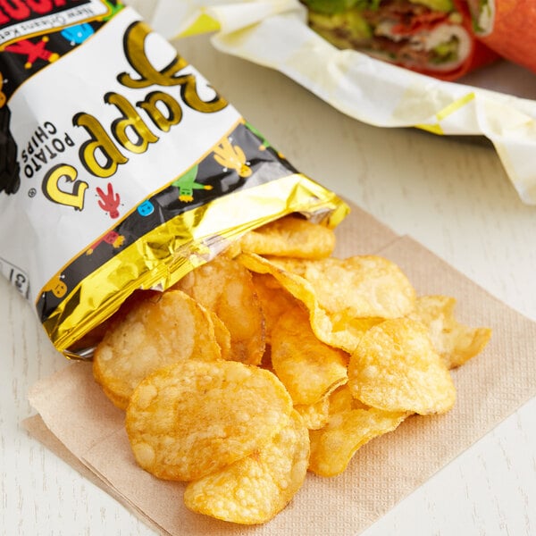 A case of Zapp's Voodoo potato chips on a table with a sandwich.