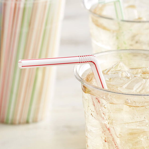 A glass of water with a Diamond LifeMade flex straw with a color stripe in a drink.