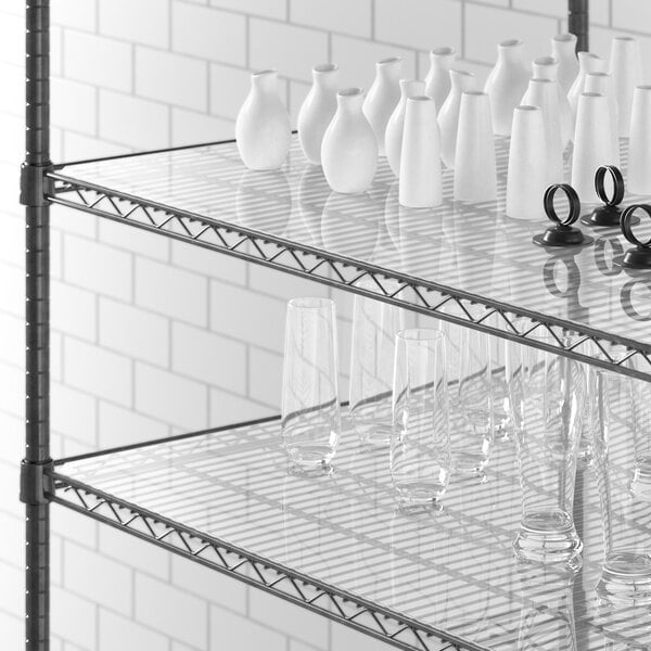 Clear PVC shelf liner on a Regency shelf with glass vases and glasses.