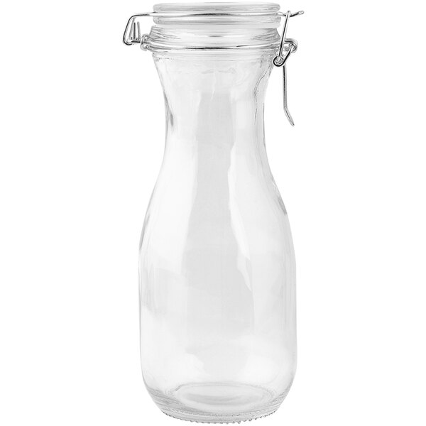 A clear glass carafe with a metal cap.