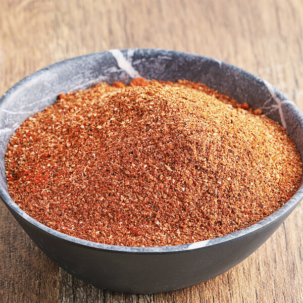 A bowl of Regal Spicy Chipotle Wing Rub on a wooden table.