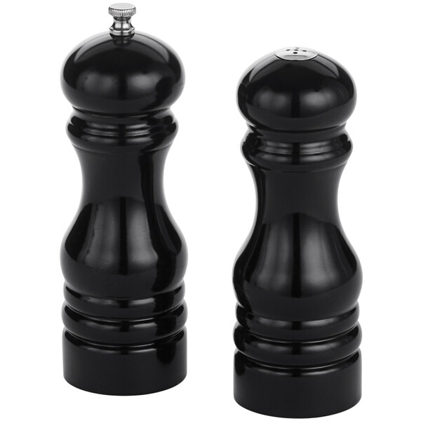 Two black wood finish salt and pepper shakers with silver tops.