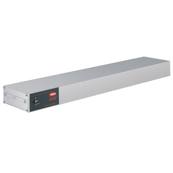 A long rectangular metal box with a black label and red lights.