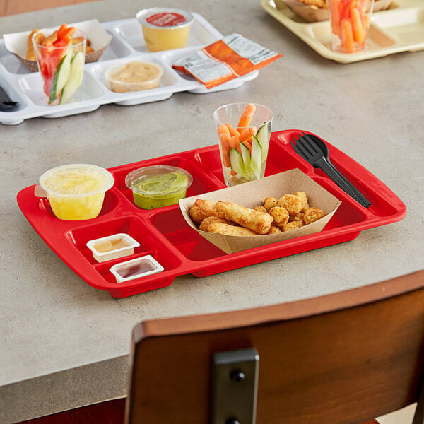 A red Choice right handed compartment tray with food in it on a table.