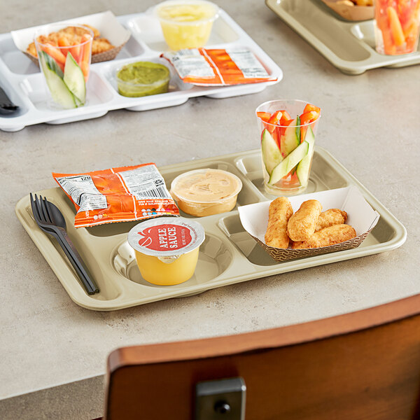 A Choice heavy-duty tan melamine compartment tray with food including a bowl of vegetables, apple sauce, and a carrot.