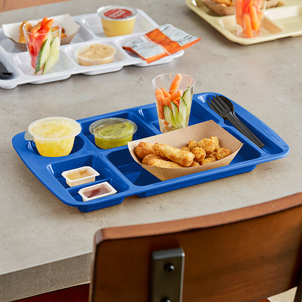 A blue Choice compartment tray with food on it on a table.