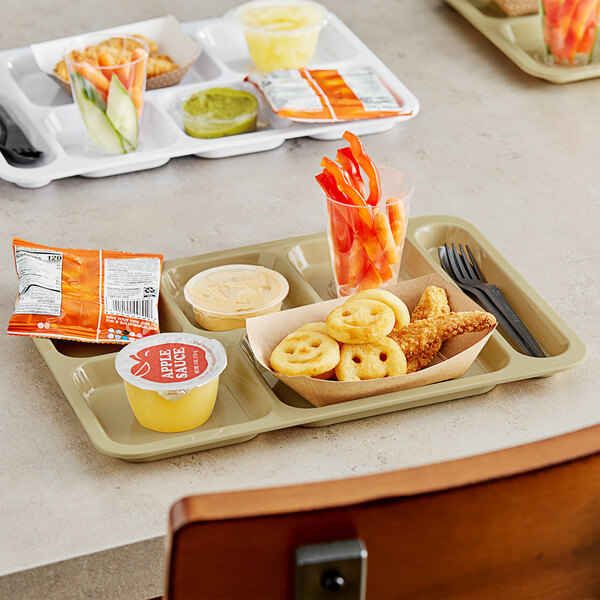 A Choice right handed heavy-duty tan melamine compartment tray with food in it on a table.
