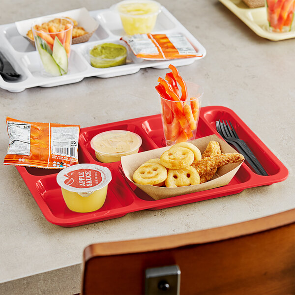 A red Choice heavy-duty melamine 6 compartment tray with food and drinks on it.