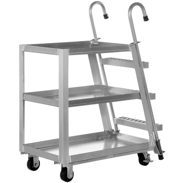 A silver metal Vestil stock picker with three shelves.