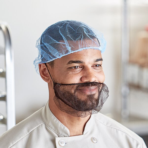 A man with a beard wearing a blue Choice nylon hairnet.