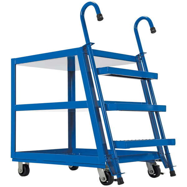A blue Vestil steel stock picker cart with three shelves on rubber-on-steel casters.
