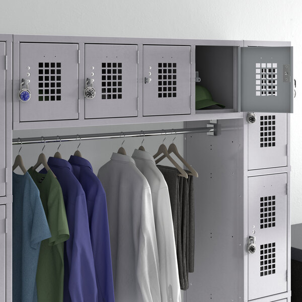 A Regency Space Solutions gray wall mount locker with several shirts hanging inside.