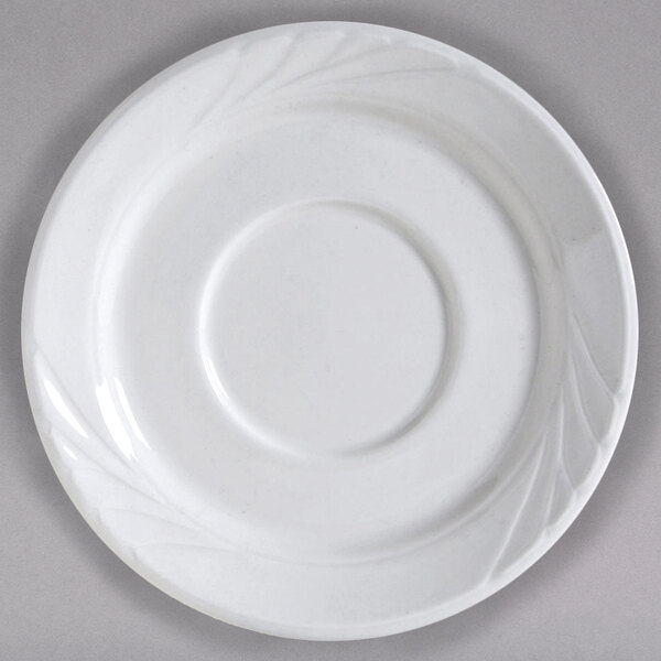 A Tuxton bright white china saucer with a circular design.