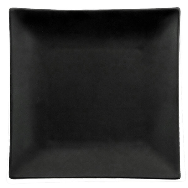 A black square stoneware plate with a non-glare glaze and white lines on the rim.