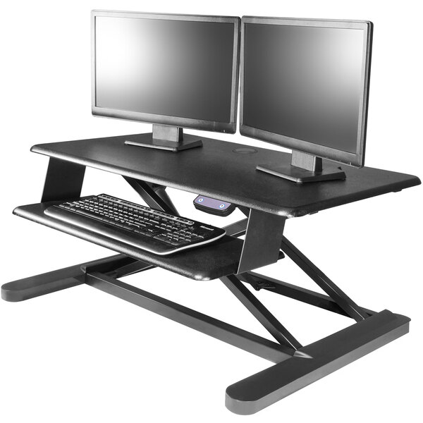 A Kantek black electric sit to stand workstation with two computer monitors and a keyboard.