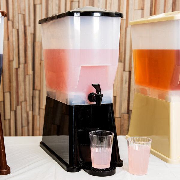 A Tablecraft black plastic beverage dispenser with pink liquid inside.