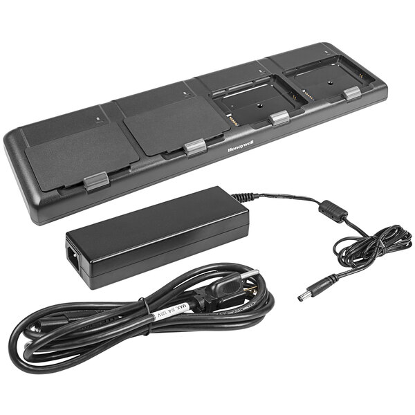 A black rectangular Honeywell Quad Battery Charger with a power cord.