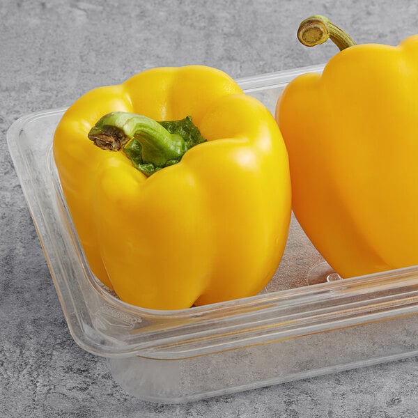 Fresh Yellow Bell Peppers in a plastic container.