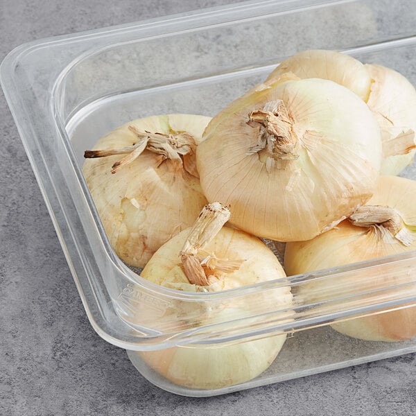 Fresh Cipollini onions in a clear plastic container.