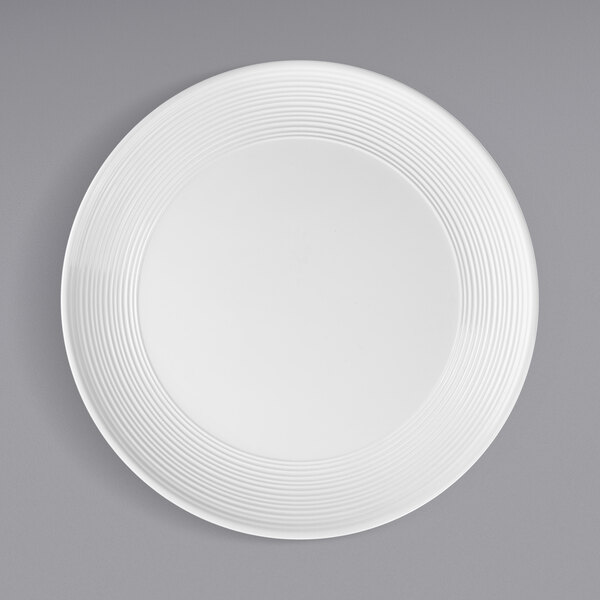 A Tablecraft white melamine plate with a swirl pattern.