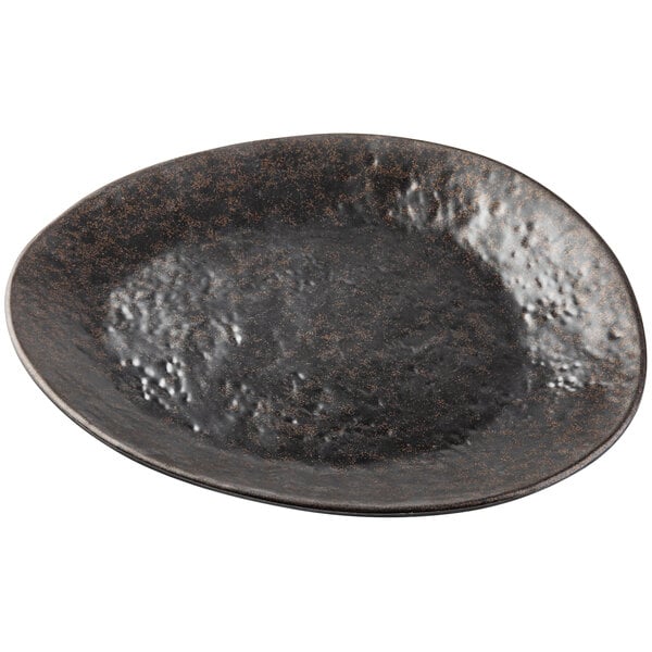 A black melamine plate with brown speckles.