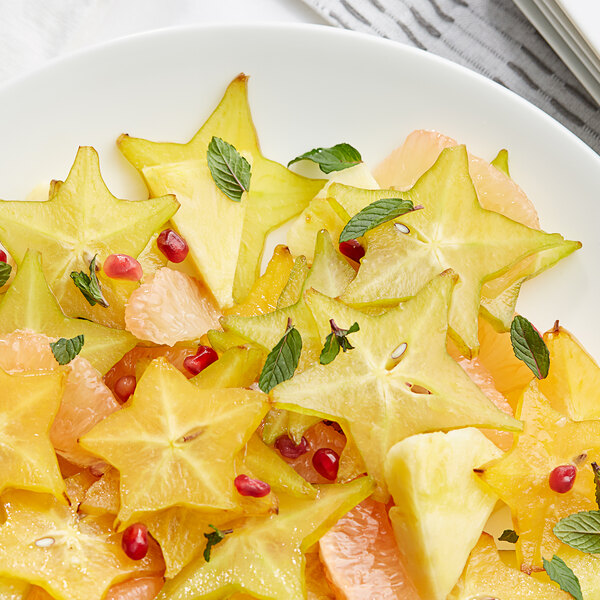 A close up of a star fruit on a plate.