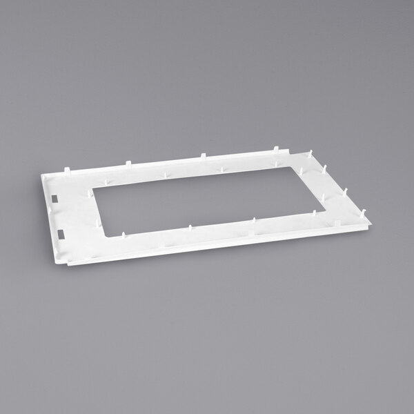 A white rectangular plastic inner door frame with holes.
