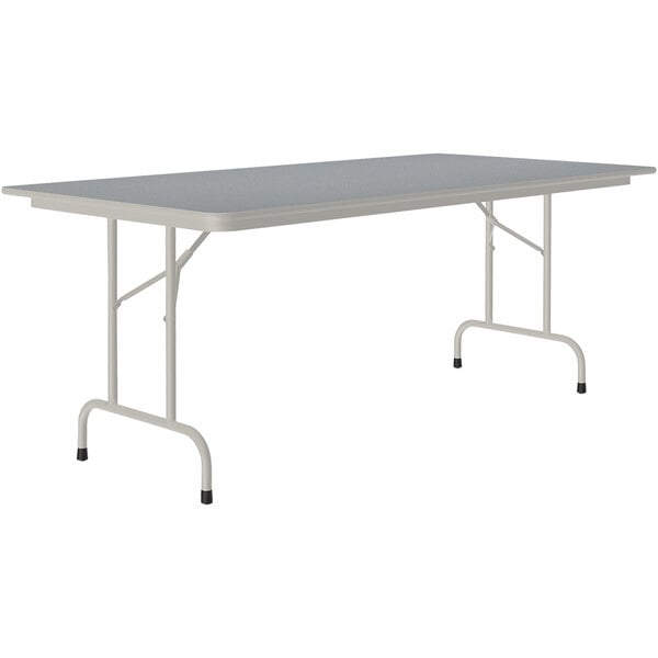 A rectangular table with a gray top and metal legs.