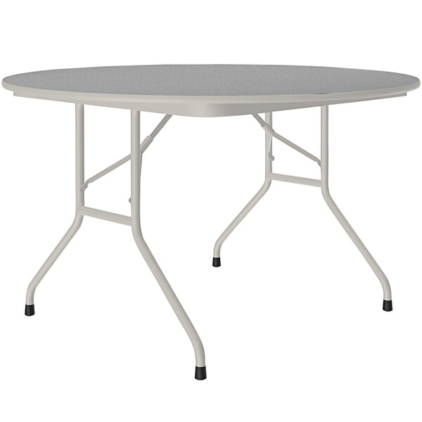 A Correll round folding table with a gray granite surface and gray metal frame.