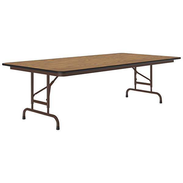 A brown rectangular Correll folding table with a thermal-fused oak top and metal legs.