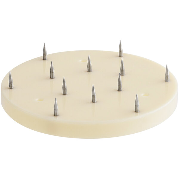 A white circular plate with spikes on it.