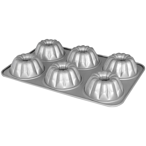 A Fat Daddio's anodized aluminum pan with 6 fluted mini cakes.