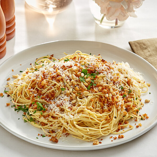 A plate of Barilla Protein+ Thin Spaghetti with parmesan cheese and pine nuts.