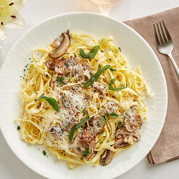 A plate of Barilla Egg Fettuccine pasta with mushrooms and cheese.