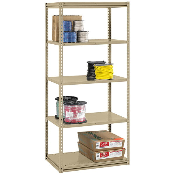 A beige Tennsco boltless steel shelving unit with several shelves holding brown boxes.