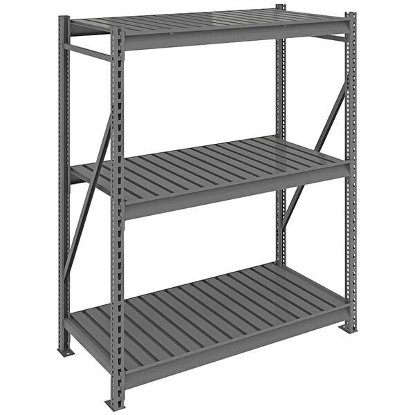 A dark gray metal Tennsco bulk shelving unit with corrugated decking on three shelves.