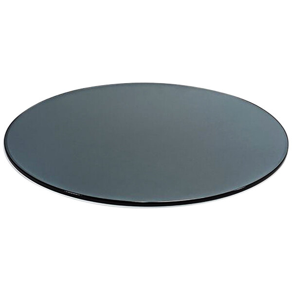 A black round glass buffet board with a black border on a table.