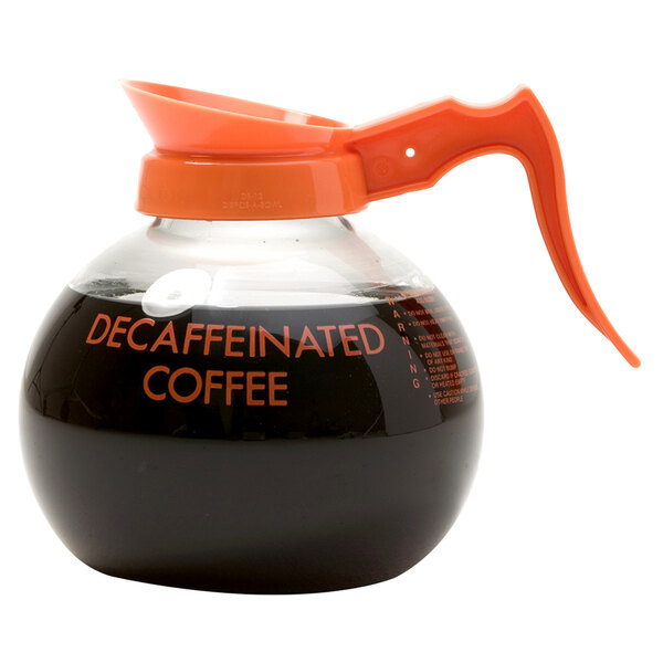 A Curtis Crystalline decaf glass coffee decanter with an orange handle and decaf logo.