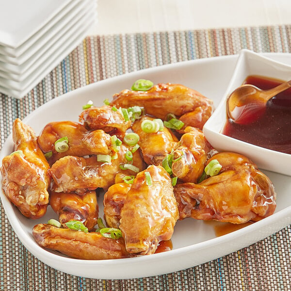 A plate of chicken wings with Sauce Craft Teriyaki Sauce.