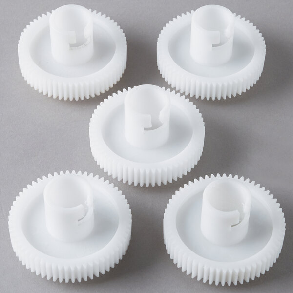 A group of white plastic gears.