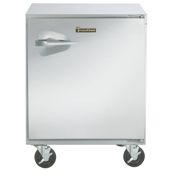 A stainless steel Traulsen undercounter freezer with a handle on wheels.
