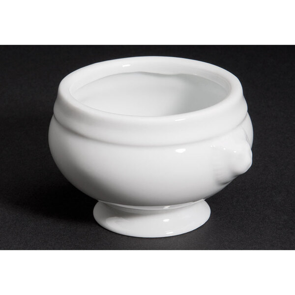 A close up of a white porcelain lion head bouillon bowl.