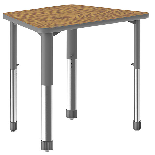 A Correll trapezoid shaped table with wooden top and metal legs.