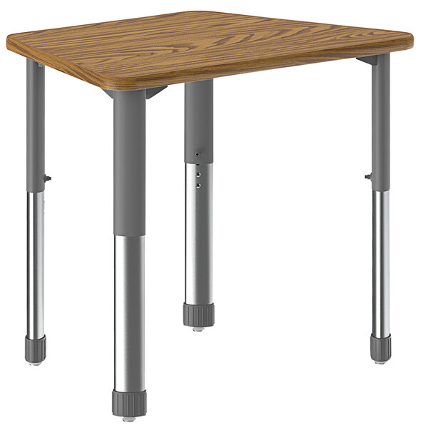 A trapezoid table with a medium oak top and metal legs with an oak band.