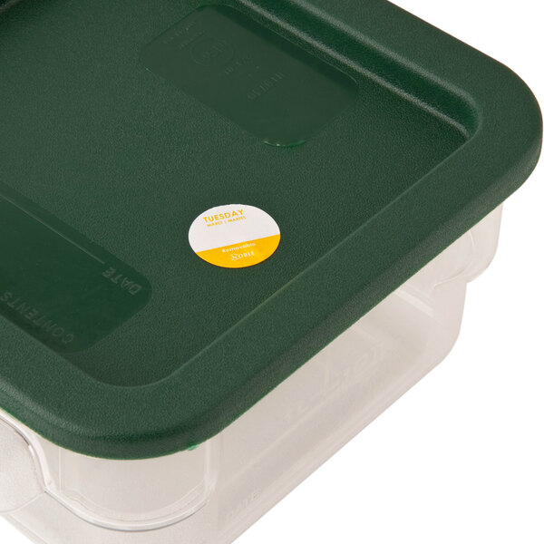 A white plastic container with a green lid filled with Noble Products Tuesday 1" Removable Day of the Week labels.