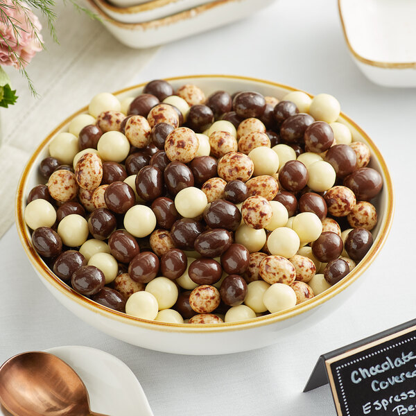 A bowl of DaVinci Gourmet chocolate and white chocolate covered espresso beans.
