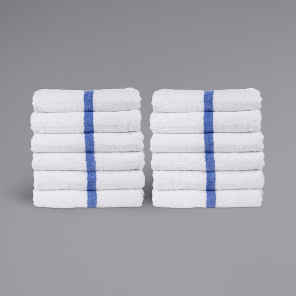 A stack of Monarch Brands white pool towels with blue stripes.